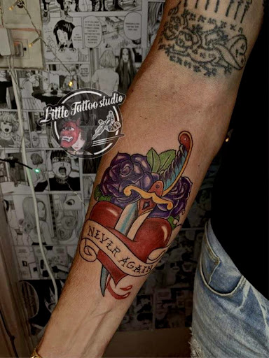 Neo-traditional color tattoo of heart, dagger and rose with banner on forearm