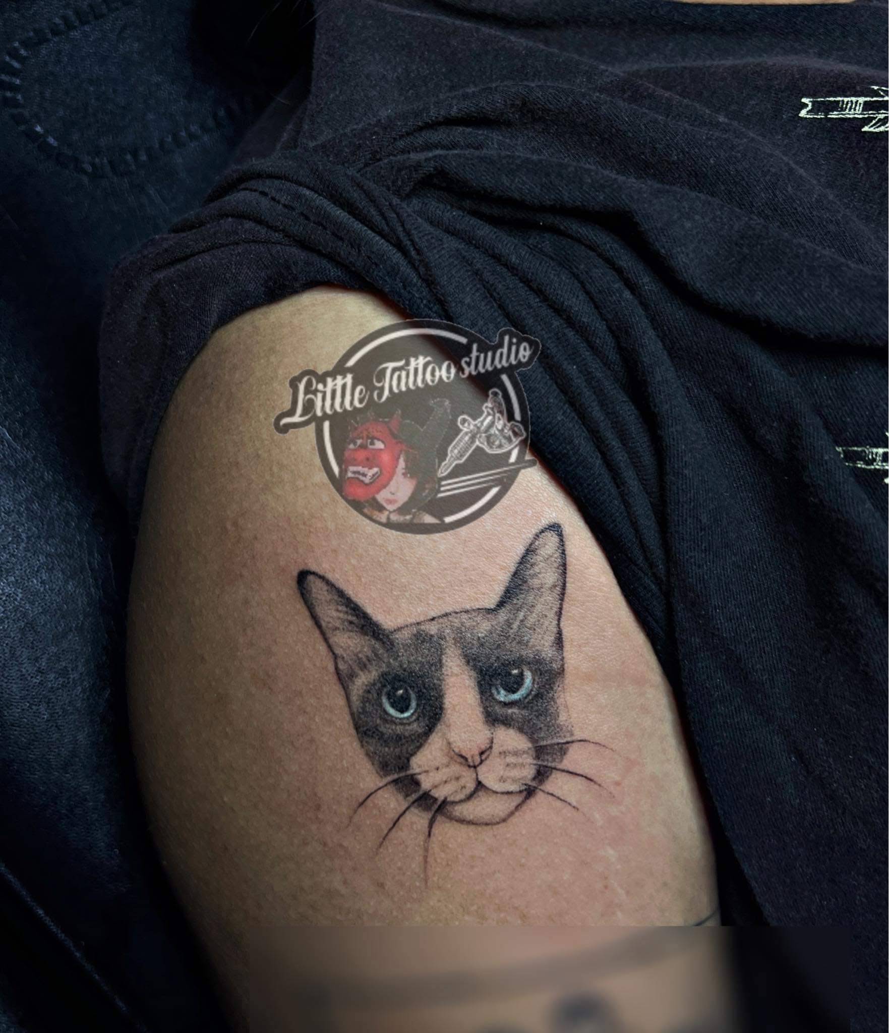Realistic cat portrait with blue eyes pet memorial tattoo on thigh